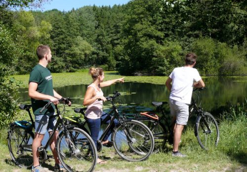 Jugendliche mit Fahrrädern an einem See